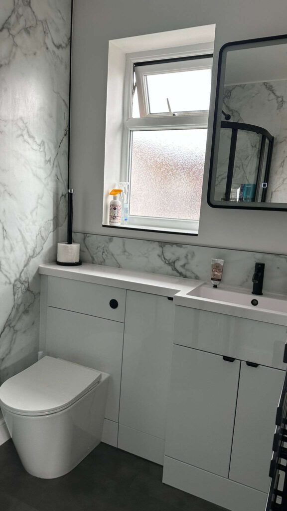 Fresh white toilet, bathroom cabinets, new window and mirror
